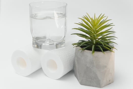 A glass of drink water and filter cartridges at white background photo