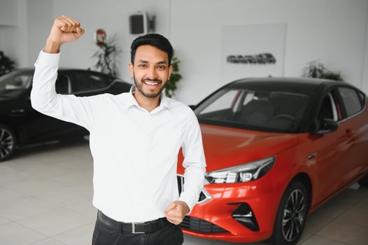Indian man adult customer male buyer client wears classic suit white shirt chooses auto wants to buy new automobile touch check car in showroom vehicle salon dealership store motor show indoor. photo