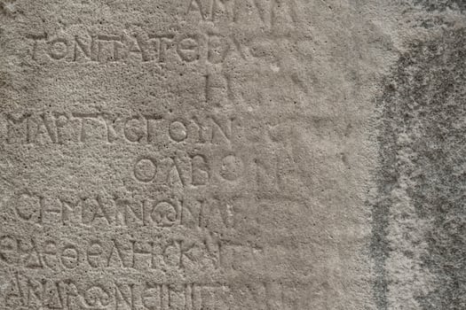 almost erased ancient Greek inscription on the stone photo