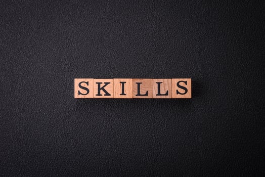 The inscription Skills made of wooden cubes on a plain background photo