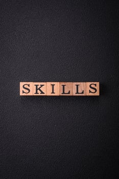The inscription Skills made of wooden cubes on a plain background photo