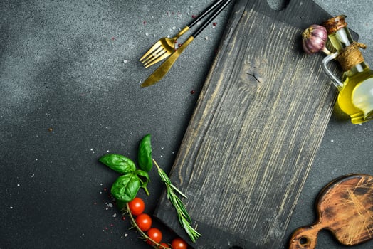 Cooking table with herbs, spices and utensils. Top view with copy space photo