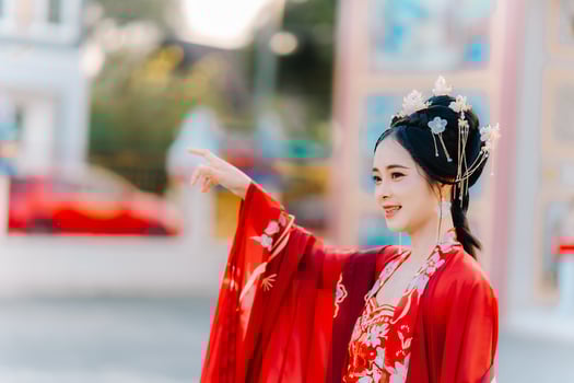 Woman dress China New year. portrait of a woman. person in traditional costume. woman in traditional costume. Beautiful young woman in a bright red dress and a crown of Chinese Queen posing. photo