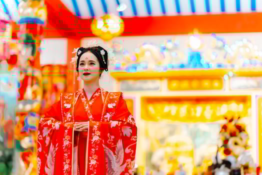 Woman dress China New year. portrait of a woman. person in traditional costume. woman in traditional costume. Beautiful young woman in a bright red dress and a crown of Chinese Queen posing. photo