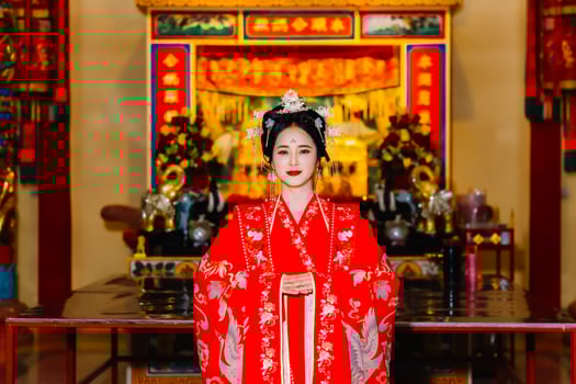 Woman dress China New year. portrait of a woman. person in traditional costume. woman in traditional costume. Beautiful young woman in a bright red dress and a crown of Chinese Queen posing. photo