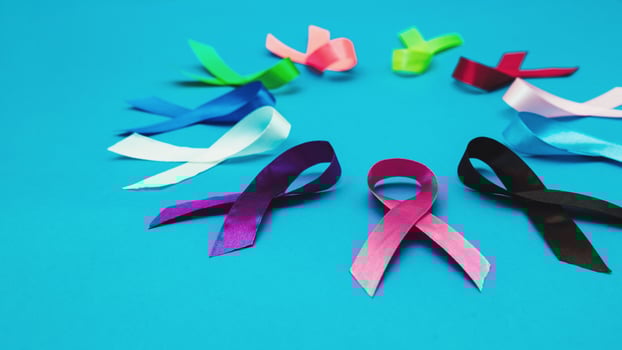 World cancer day February 4 background. Colorful ribbons, cancer awareness. blue surface from above photo