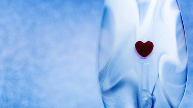 Plain blue background with little red heart photo