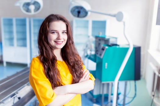 Beautiful girl doctor smiling. bright portrait. Concept of the doctor background in yellow form in the operating room. photo