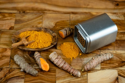 Turmeric Curcuma longa the yellow spice on olive wood photo