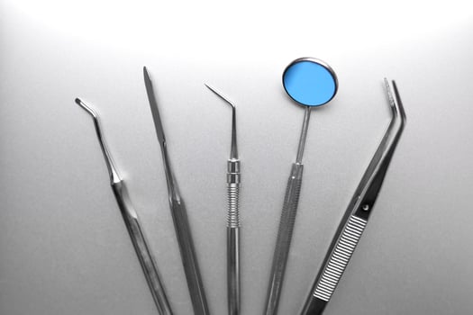 Dental tools on silver color background photo
