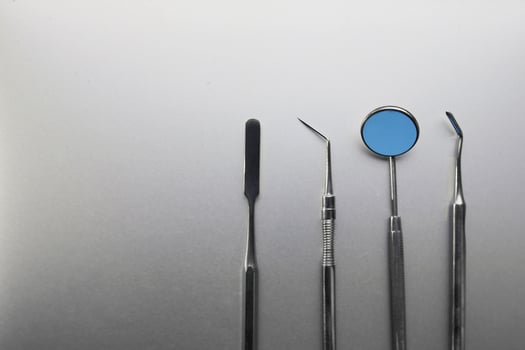 Dental tools on silver color background photo