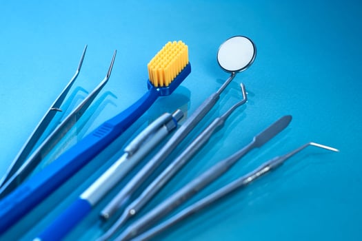 Dentist tools. Teethcare, dental health concept. Blue background top view copy space photo
