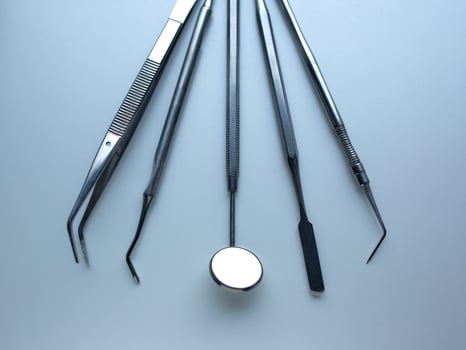 Dental tools on silver color background photo
