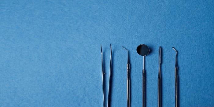 Dentist tools. Professional steel dental instruments with background with free space. photo