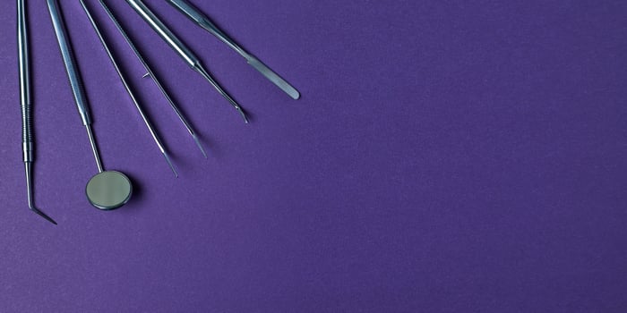 Dentist tools. Professional steel dental instruments with background with free space. photo