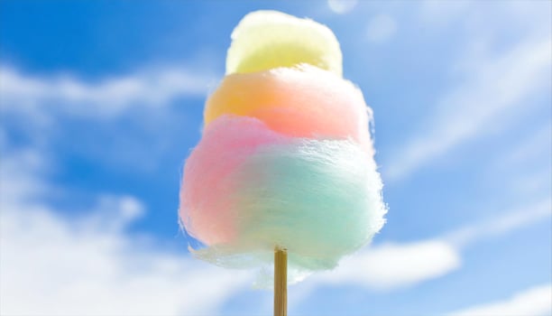 AI generated a cotton candy on a stick with a blue sky in the background photo