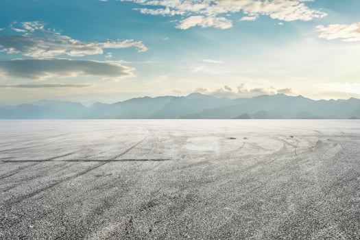 Asphalt race track ground and mountain with sunset clouds photo