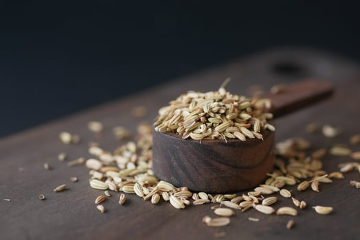 cumin seeds on spoon on table , close up photo