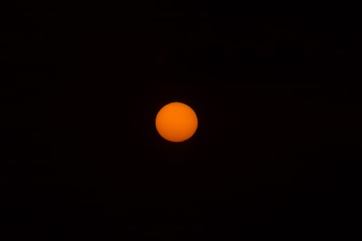 Orange sun in the dark sky. photo