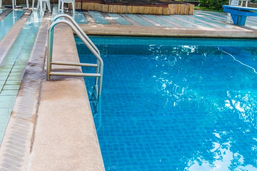 A blue pool with a ladder photo