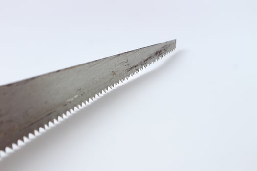 Hand saw with yellow plastic handle photo