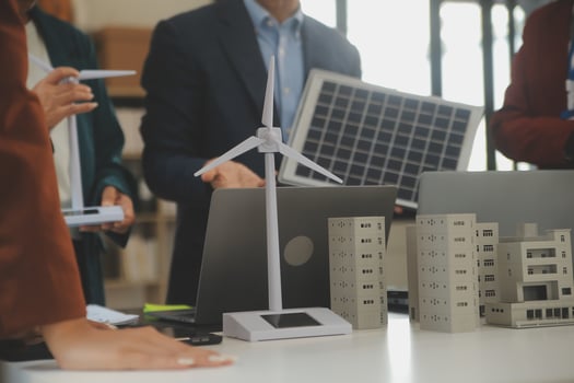 Close-up at tablet, Engineers pointing at tablet with their hands. To jointly design the use of renewable energy with wind and solar energy. Concept of using renewable energy. photo