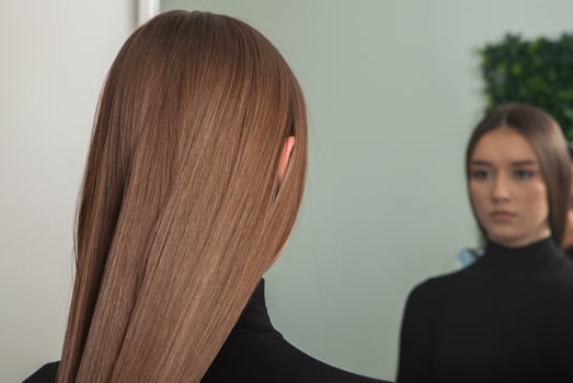Portrait of a beautiful woman with long brown straight hair in a beauty salon. photo