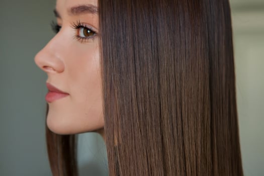 Portrait of a beautiful woman with long brown straight hair in a beauty salon. photo