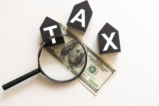 TAX wooden cubes on the chart background , look through a magnifier photo