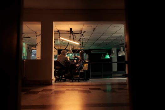 Diverse team of thieves coding trojan virus late at night, hacking computer system with malware. Young hackers planning to crack server, looking to steal passwords, malicious software. photo