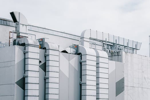 Rooftop air vent ways flow ventilator system. air conditioner pipe line in large mall building city landscape outdoors photo