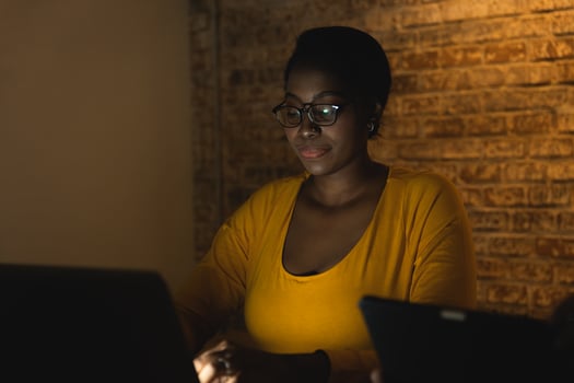 african black business woman night working on laptop computer hard work overnight photo