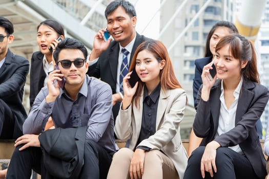Young Asian business team discussing in the morning, Young businesspeople sitting on stairs with friends, Business people meeting and sharing ideas photo