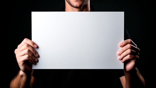 AI generated Man holding a white sheet of paper on a black background. Mockup. photo