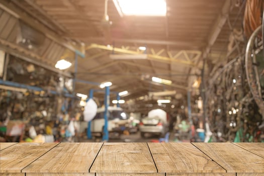 blur old garage interior with wooden table space for car service products advertising montage background photo