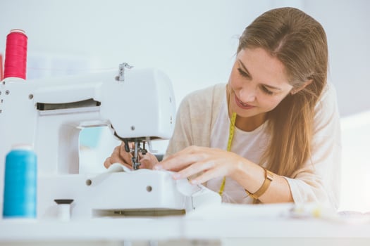 costume professional woman work enjoy with digital sewing machine happy in tailor studio photo