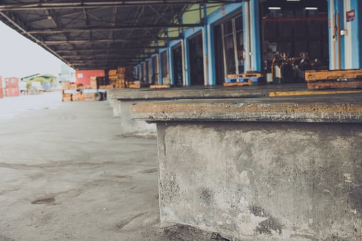 truck shipping docks or cargo loading area at large warehouse building photo