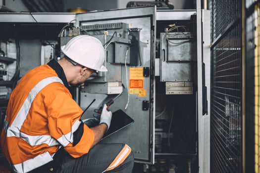 electricity engineer male dangerous working fix service high voltage electrical cabinet. worker repair electric surge problem problem in industry factory. photo