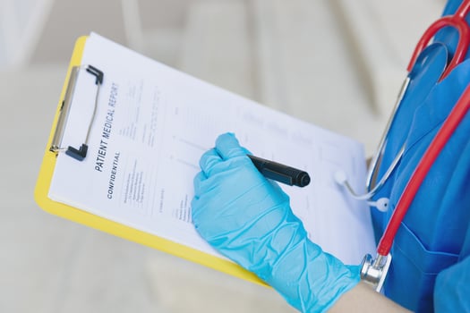 Doctor nurse writing followup information in medical examination document for patient health check in hospital or clinic. photo