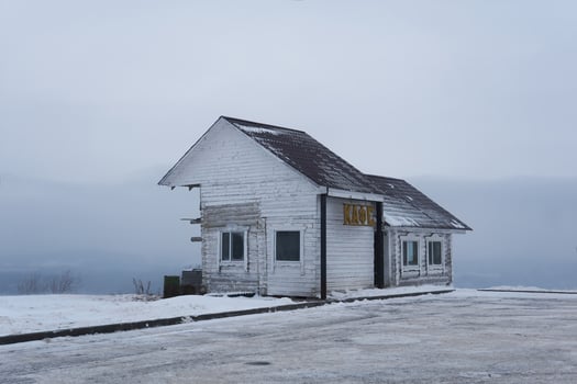 old wooden building of a transport cafe on a mountain pass in a snowy winter landscape in Perm Krai, Russia photo