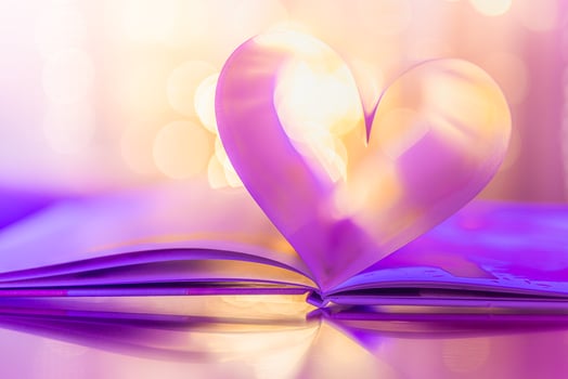 Closeup love Valenstines day design. Perfect heart shape book pages romantic. Vintage style copy space text lights reflections. Beautiful February Valentine day artistic background. Couple anniversary photo
