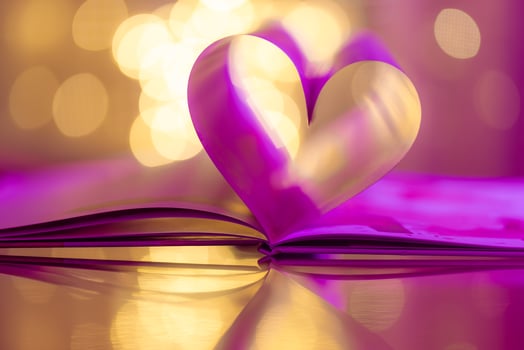 Closeup love Valenstines day design. Perfect heart shape book pages romantic. Vintage style copy space text lights reflections. Beautiful February Valentine day artistic background. Couple anniversary photo