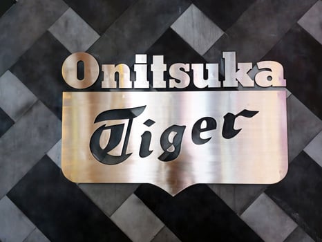 BANGKOK, THAILAND  DECEMBER 21, 2023 Onitsuka Tiger sign. Onitsuka Tiger is a famous Japanese sports fashion brand started in 1949. photo