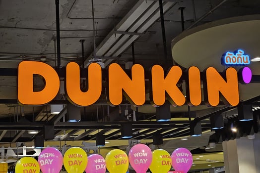 BANGKOK, THAILAND JULY 09, 2023 Dunkin Sign. Dunkin is a famous glasses store in Thailand. Dunkin is an American multinational coffee and doughnut company that was founded in 1950. photo