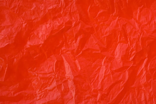 Red crumpled paper texture photo