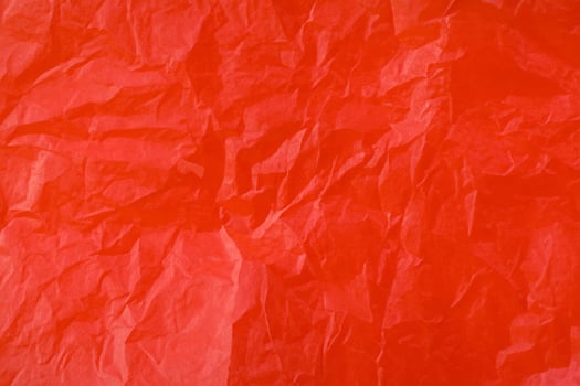 Red crumpled paper texture photo