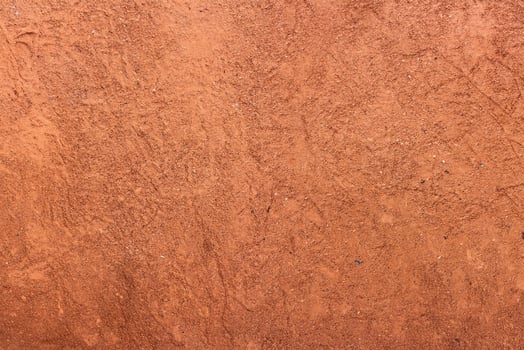 Red sand texture with shoe prints on top photo