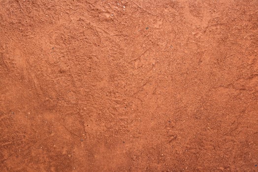 Red sand texture with shoe prints on top photo