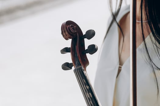 A fragment of an electric violin, a violin in the hands of a musician's girl photo