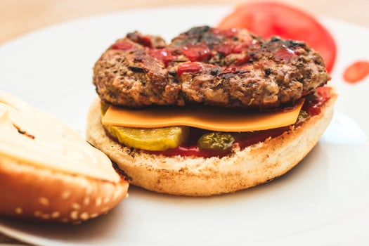 Buns for homemade burgers with ketchup and cutlet lie on a plate. photo